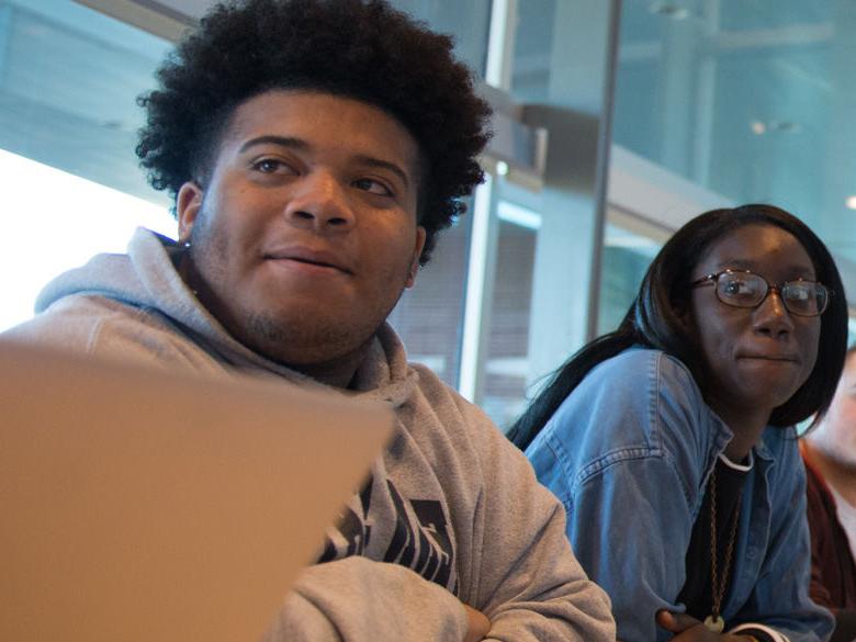 Two students listening in class.